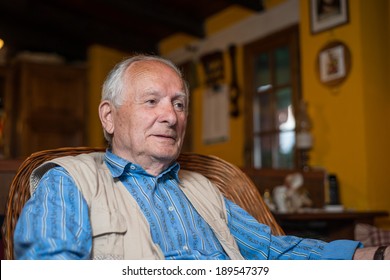 Retired Man At Home Watching TV.