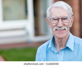 Retired Man Smiling Outside His House