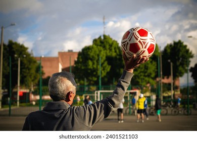 retired older man being a goalkeeper on a soccer field in a park - Powered by Shutterstock