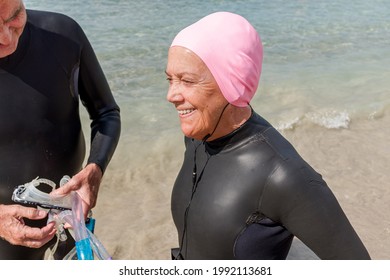 Retired Older Woman Dressed In A Wetsuit Wearing A Pink Swim Cap