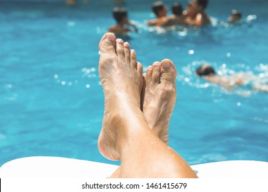 Retired Resting By The Pool While Grandchildren Swim.