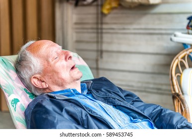 Retired Senior Adult Sleeping On His Chair.