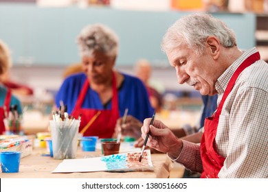 Retired Senior Man Attending Art Class In Community Centre