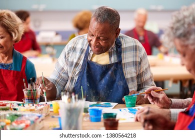 Retired Senior Man Attending Art Class In Community Centre