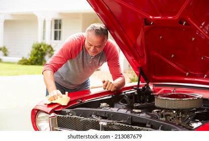 Retired Senior Man Cleaning Restored Classic Car