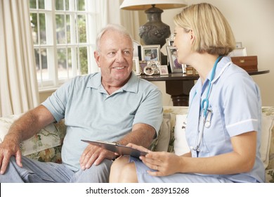 Retired Senior Man Having Health Check With Nurse At Home