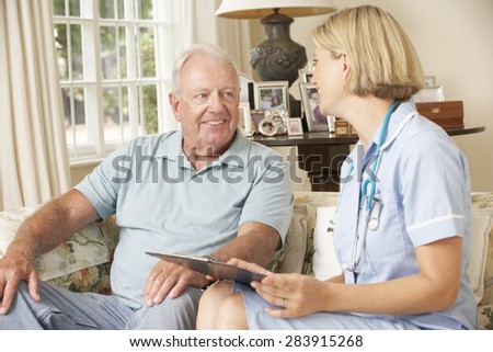 Retired Senior Man Having Health Check With Nurse At Home