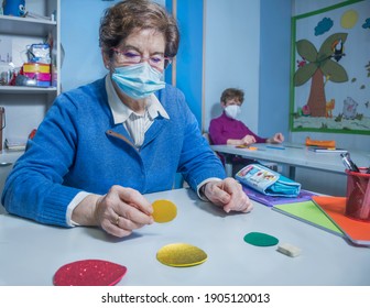 Retired Senior Woman Attending Class In Community Center, Wearing Face Mask, Social Distancing.  Keeping Social Distance In Classroom. Memory Exercises.