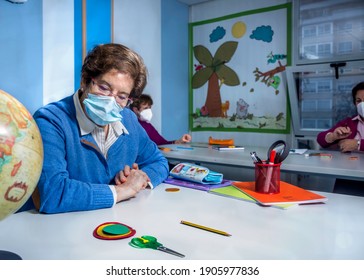 Retired Senior Woman Attending Class In Community Center, Wearing Face Mask.  Keeping Social Distance In Classroom. Memory Exercises.