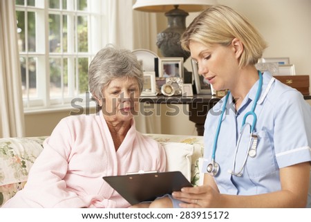 Retired Senior Woman Having Health Check With Nurse At Home
