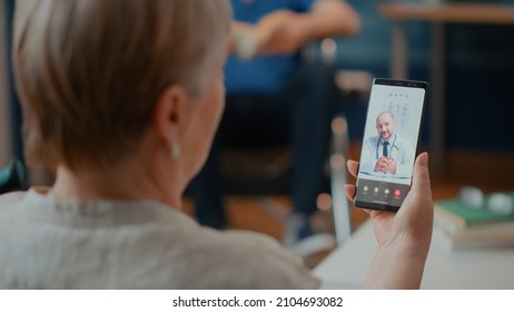 Retired woman attending online consultation on videocall with medic, talking about health care. Senior adult using online videoconference with doctor for telemedicine and telehealth. - Powered by Shutterstock