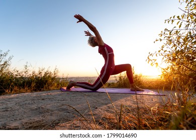 Retired Woman In A Pose Crescent Moon Doing Yoga At Sunrise