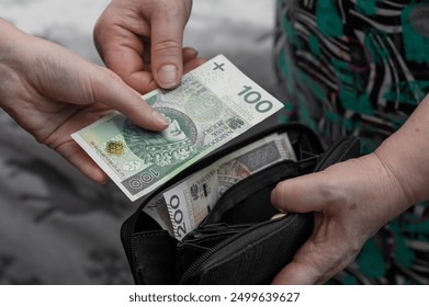 Retiree taking money out of wallet, handing cash to someone - Powered by Shutterstock