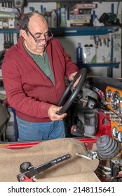 Retiree Thinking How To Adjust The Steering Wheel In The Car He Is Restoring