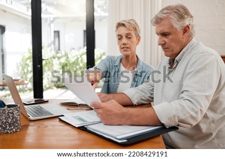 Retirement couple budget, finance and investment planning, loan and paper bills for online banking at home. Senior man, woman and people reading tax money report, cash savings and admin document note