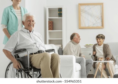 Retirement Home With Elder Man On A Wheelchair