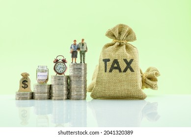 Retirement, pension income tax credit and social security concept : Older couple, clock, saving bottle, US dollar bag on row of coins, depicts collecting money for retirement after long time working - Shutterstock ID 2041320389