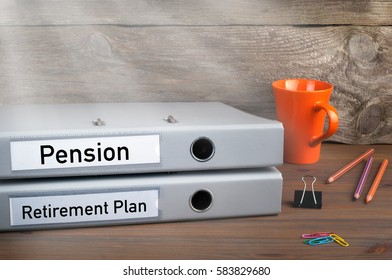 Retirement Plan And Pension - Two Folders On Wooden Office Desk