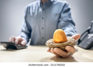 Retirement savings golden nest egg in a mans hand