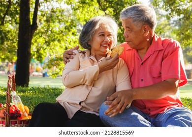 Retirement Senior Couple Health Care Concept : Asian Senior Couples Camping Together In A Shady Garden Showing Love, Feeding Snacks With Love And Care, Are Happy To Take Care Of Each Other.