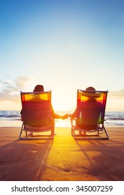 Retirement Vacation Concept, Happy Mature Retired Couple Enjoying Beautiful Sunset At The Beach