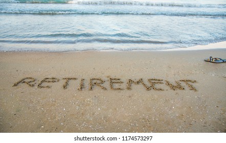 Retirement Written On Sand By Sea At Beach