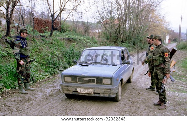 RETMILJE, KOSOVO,  12 NOVEMBER 1998 ---\
Soldiers of the Kosovo Liberation Army (KLA) stop a car at a\
makeshift roadblock in the Drenica\
Triangle.