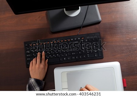Retoucher is doing her work using computer in the office