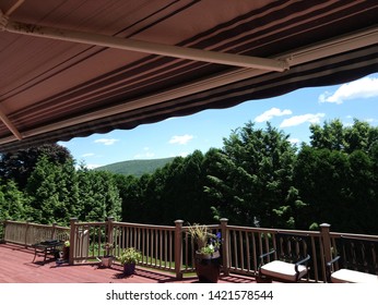 Retractable Awning On Backyard Deck In Summer