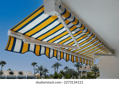 retractable manual awning above apartment balcony