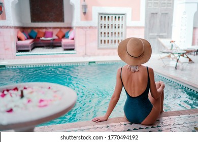 Retreat And Vacation. Beautiful Young Woman Relaxing In Spa Private Swimming Pool In Beautiful Moroccan Backyard.