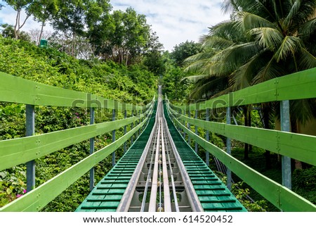 Retreating view on the road of a large rollercoaster with trolley in Vinpearl, Vietnam