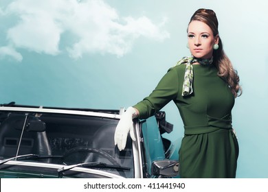 Retro 1960s Woman In Green Dress Standing Next Sportscar.