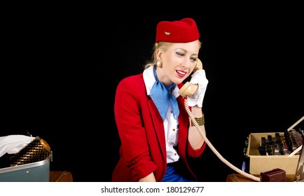 Retro Airline Stewardess Or Flight Attendant Talking On The Phone While Preparing For Work.