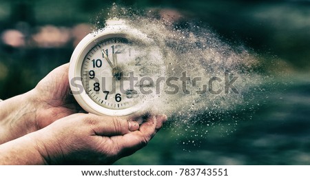 Retro alarm clock or vintage alarm clock in old hand. Time is running out concept shows clock that is dissolving away into little particles ストックフォト © 