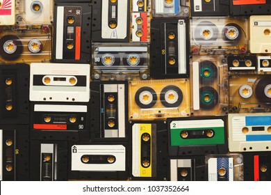 Retro audio cassette tapes on beige background. Top view on vintage media devices, copy space on labels, flat lay