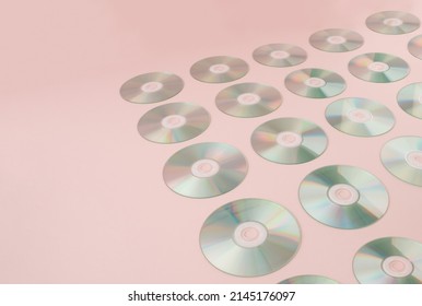 Retro Background With Digital Audio Compact Discs On Pink Background.