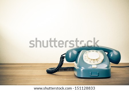 Retro background with rotary telephone on wood table