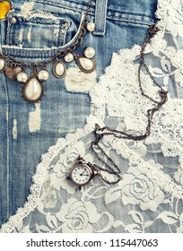 retro background with vintage jewelry and jeans texture