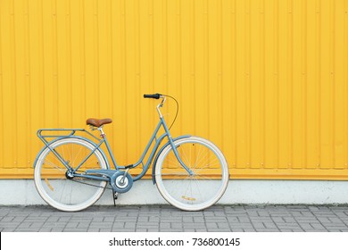Retro bicycle near yellow wall outdoors