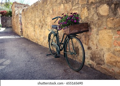 retro bike with flowers standing on a street of small italian town
 - Powered by Shutterstock