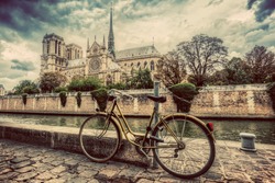 Retro Bike Next To Notre Dame Cathedral In Paris, France And The Seine River. Vintage