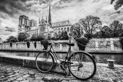 Retro Bike Next To Notre Dame Cathedral In Paris, France And The Seine River. Black And White Vintage
