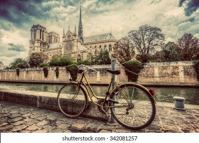 Retro bike next to Notre Dame Cathedral in Paris, France and the Seine river. Vintage