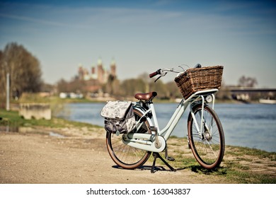 Retro Bike standing in Front of the View of the medieval romanic Cathedral and the River Rhine at Speyer Germany - Powered by Shutterstock