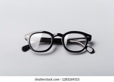a retro black framed glasses on a gray background