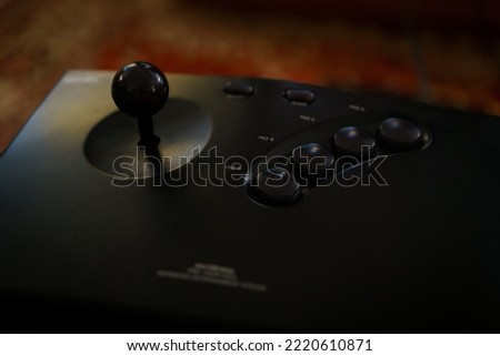 Retro black joystick with buttons.