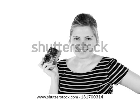 Retro black and white monochrome of beautiful young blond woman holding an antique camera. Hair teased up in bun. Photo in studio on white background and in Black and white.
