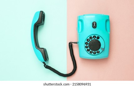 Retro Blue Old Fashioned Rotary Phone On Pink Blue Background. Top View