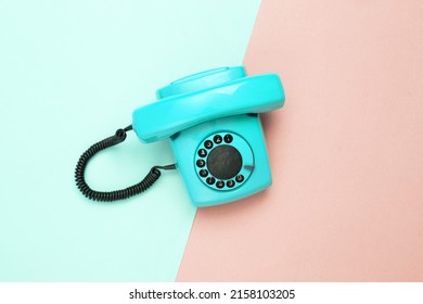 Retro Blue Old Fashioned Rotary Phone On Pink Blue Background. Top View